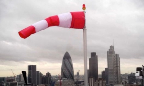 A windsock blowing out at right angles on the end of a flagpole, referencing the windy weather we have been having this week.