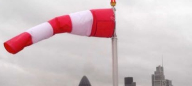 A windsock blowing out at right angles on the end of a flagpole, referencing the windy weather we have been having this week.